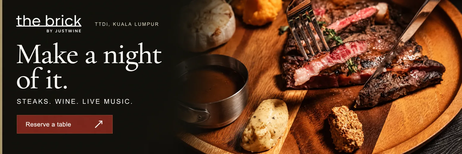 Advertisement for The Brick by Justwine in TTDI, Kuala Lumpur. Make a night of it. Steaks, wine and live music. Reserve a table on WhatsApp.