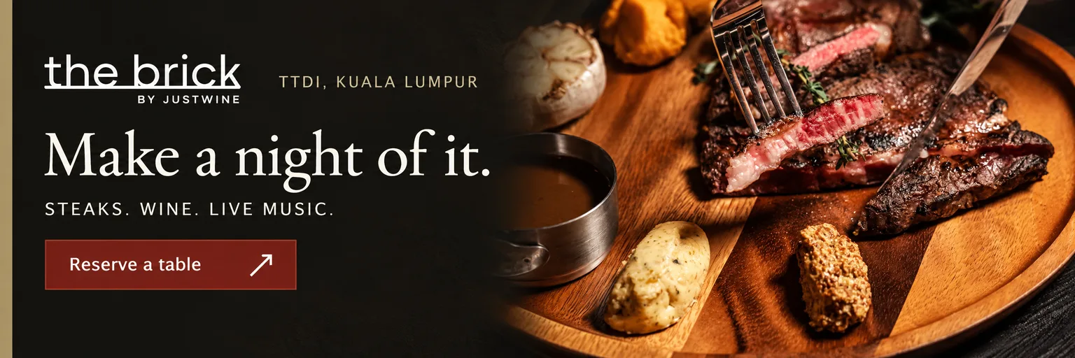 Advertisement for The Brick by Justwine in TTDI, Kuala Lumpur. Make a night of it. Steaks, wine and live music. Reserve a table on WhatsApp.