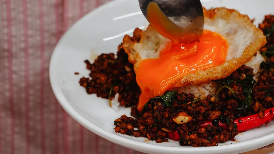 Chicken Pad Krapao topped with a crispy duck egg. Photography supplied.