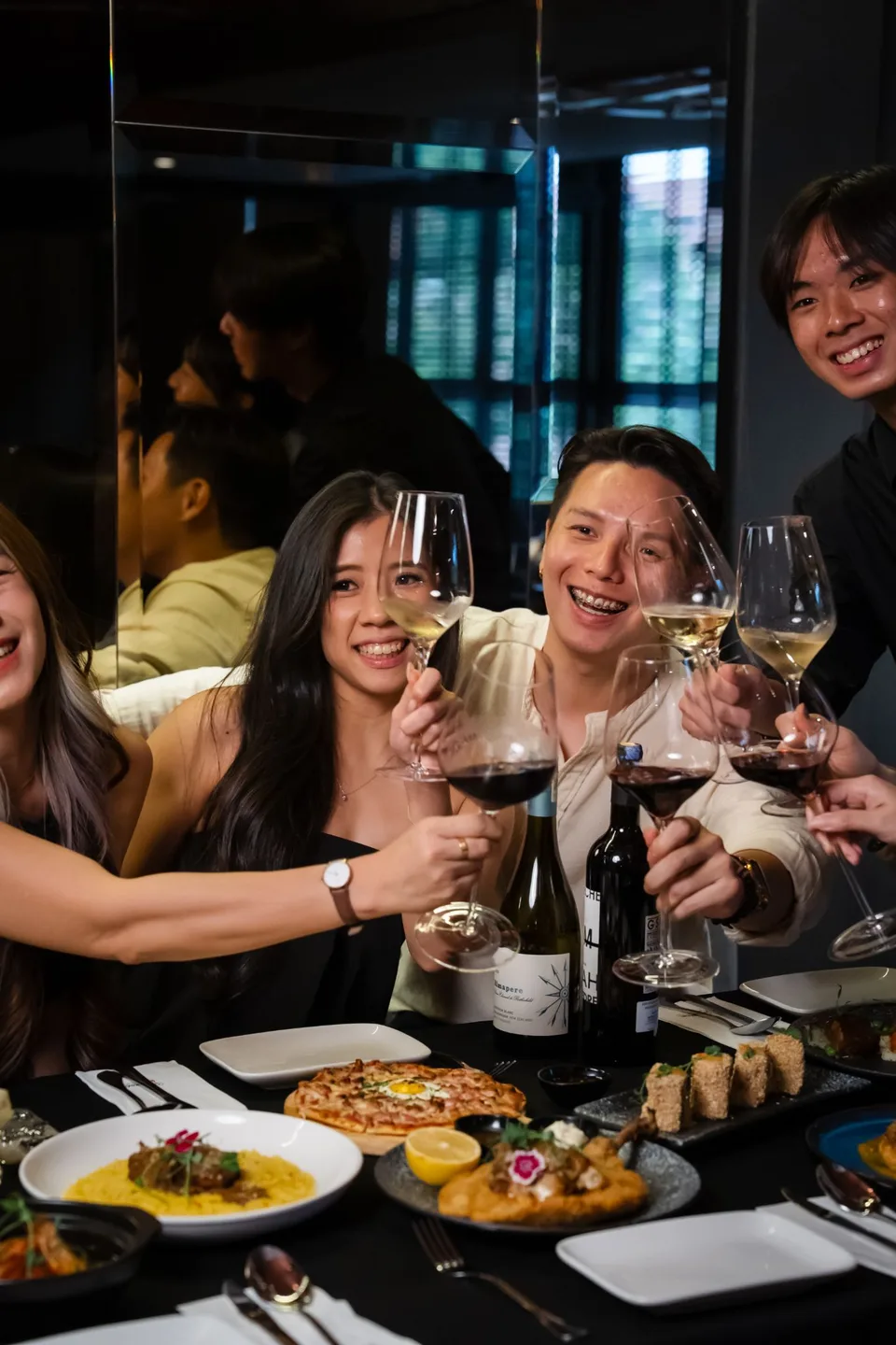 Seafood pasta and guests sharing wine at The Brick by Justwine. Photographs supplied with the restaurant brief.